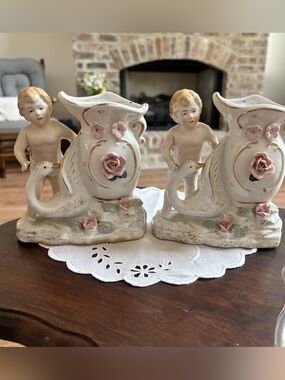 Pair of Porcelain Cherub Vases with Pink Floral Accents and an Onlooking Goose